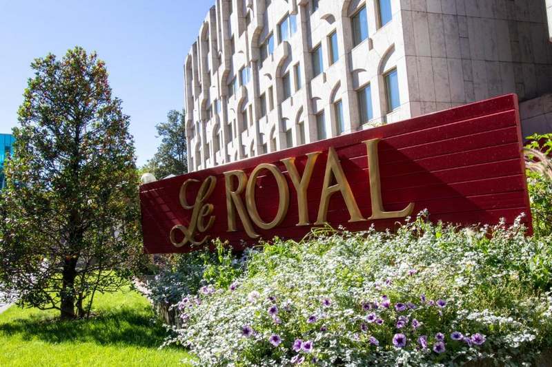 The red Le Royal sign in the garden in front of the hotel on Boulevard Royal.
