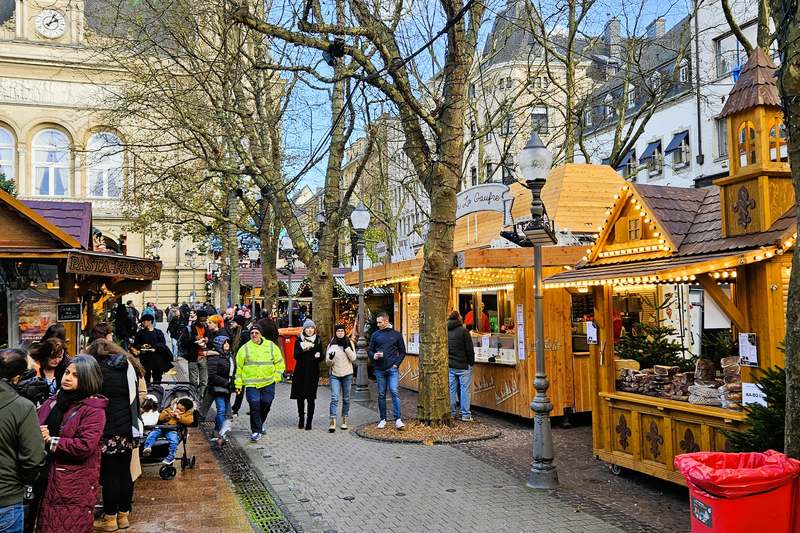 Wooden chalets lining the Christmas market street in Luxembourg's old town.